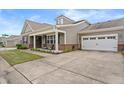 Inviting home with an attached two-car garage, covered porch, and well-maintained lawn at 4612 Hanging Fern Ln, Raleigh, NC 27604