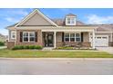 Beautiful home with a covered porch, dark shutters, landscaped lawn, and attached garage at 4612 Hanging Fern Ln, Raleigh, NC 27604
