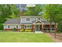 Charming two-story home with a brick facade, well-manicured lawn, and inviting front porch at 504 S Dixon Ave, Cary, NC 27511