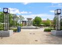 Frantz Square water fountain flanked by patterned light fixtures and lush greenery on a bright sunny day at 504 S Dixon Ave, Cary, NC 27511