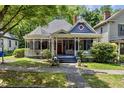 Charming historic home with a classic wraparound porch and lush green lawn at 517 N East St, Raleigh, NC 27604