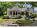 Quaint Victorian home featuring a welcoming porch, and lush green lawn at 517 N East St, Raleigh, NC 27604