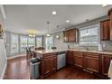 Kitchen featuring stainless steel appliances, recessed lighting, dark cabinets, and dining area with lots of natural light at 5321 Longspur Dr, Snow Camp, NC 27349