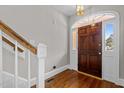 Bright foyer featuring hardwood floors, a decorative front door and stairs leading upstairs at 6728 Pointe Vista Cir, Raleigh, NC 27615