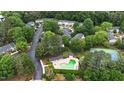 Aesthetic aerial view of community amenities and buildings surrounded by lush trees and greenery at 7719 Kingsberry Ct, Raleigh, NC 27615