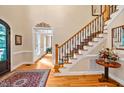 Grand foyer featuring hardwood floors, staircase with decorative railing, and elegant decor at 8 Pine Top Pl, Durham, NC 27705