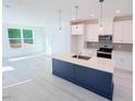 Modern kitchen with white cabinets, an island, and stainless steel appliances at 1003 Regalia Rd # 33, Durham, NC 27713