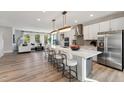 Bright, airy kitchen with stainless steel appliances, a large island, and stylish pendant lighting at 103 Ailey Brook Way # 200, Wake Forest, NC 27587