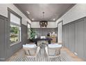 Bright home office with patterned wallpaper, modern lighting, and comfortable seating at 1049 Coldspring Circle, Durham, NC 27705