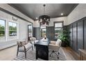 Sophisticated home office featuring a modern desk, stylish chandelier, and walls accented with wainscoting at 1049 Coldspring Circle, Durham, NC 27705