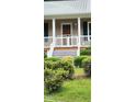 Inviting front porch with white railing and gated stairs leading to a cozy entrance at 107 Oak Park Dr, Benson, NC 27504