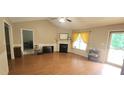 Spacious living room featuring a fireplace, wood flooring, and plenty of natural light at 107 Oak Park Dr, Benson, NC 27504