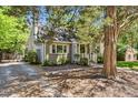Quaint single-story home with a manicured front yard, mature tree, and classic brick facade at 1304 N Duke St, Durham, NC 27701