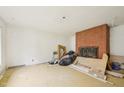 Spacious living room featuring a brick fireplace with exposed brick; ready for remodel or renovation at 1407 Arnette Ave, Durham, NC 27707