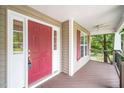 Inviting front porch with a red door and a window with charming red shutters at 1601 Balkan Rd, Fuquay Varina, NC 27526