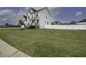 Charming two-story home with a well-manicured lawn and a white picket fence at 170 Kinsale Ct, Garner, NC 27529