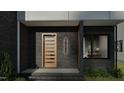 Close-up of townhome entrance featuring a contemporary glass and wood door, along with modern lighting at 1804 Pershing Rd, Raleigh, NC 27608