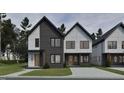 Contemporary two-story townhomes showcase modern design with clean lines and contrasting textures at 1806 Pershing Rd, Raleigh, NC 27608