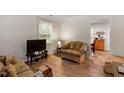Cozy living room featuring wood floors, natural light, and comfortable seating arrangement at 2 Capri Ter, Durham, NC 27703