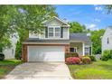 Two-story home with attached garage, trimmed with flowers, and nice curb appeal at 248 Inkster Cv, Raleigh, NC 27603