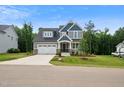Charming two-story home with a manicured lawn and a welcoming two-car garage at 271 W Amber Oak Dr, Selma, NC 27576