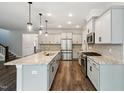 Modern kitchen featuring stainless steel appliances, granite countertops, and a large island at 271 W Amber Oak Dr, Selma, NC 27576