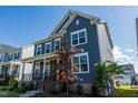 Attractive two-story home featuring a covered front porch and vibrant landscaping at 2918 Heirloom Way, Apex, NC 27502