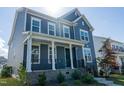 Charming two-story home with a covered front porch and well-maintained lawn at 2918 Heirloom Way, Apex, NC 27502