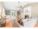 Cozy living room with a stone fireplace, built-in bookcases, and French doors at 318 Fieldstone Dr, Burlington, NC 27215