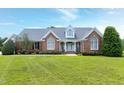 Charming brick home featuring a well manicured lawn and inviting front porch at 4005 Olde Waverly Way, Fuquay Varina, NC 27526