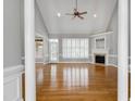 Spacious living room with vaulted ceilings, hardwood floors, and a cozy fireplace at 4005 Olde Waverly Way, Fuquay Varina, NC 27526