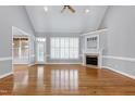 Spacious living room with vaulted ceilings, hardwood floors, and a cozy fireplace at 4005 Olde Waverly Way, Fuquay Varina, NC 27526