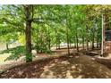 Lush backyard with shade trees and large brick paver patio at 405 Commons Walk Cir, Cary, NC 27519