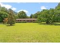 Spacious front yard with mature trees surrounding the brick home at 462 Sullivan Rd, Selma, NC 27576