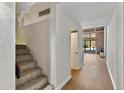 Bright hallway with hardwood floors leading towards living area with stairs to upper level at 500 N Duke St # 55-105, Durham, NC 27701