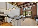 Inviting living space with exposed brick, hardwood floors, and an open layout connected to the kitchen at 500 N Duke St # 55-105, Durham, NC 27701