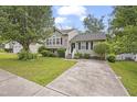 Charming two-story home with a well-maintained front yard and a concrete driveway at 6927 Beaverwood Dr Dr, Raleigh, NC 27616
