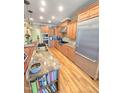 Spacious kitchen with granite countertops, stainless steel appliances, and natural wood floors at 7483 Danford Rd, Burlington, NC 27215