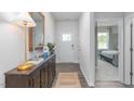 Bright entryway showcases hardwood floors, console table, a front door view, and access to the bedroom at 806 Comice Pear Way, Willow Springs, NC 27592