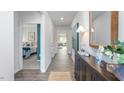 Inviting entryway features hardwood floors, stylish console table with decor, and a view into the bedroom at 806 Comice Pear Way, Willow Springs, NC 27592