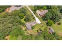Aerial view of a home with a long driveway surrounded by trees at 8133 Holly Forest Rd, Wake Forest, NC 27587