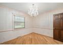Elegant dining room with hardwood floors, chandelier, and wainscoting at 8133 Holly Forest Rd, Wake Forest, NC 27587
