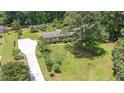 Beautiful exterior of a home with a well-manicured lawn and mature trees at 8133 Holly Forest Rd, Wake Forest, NC 27587