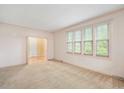 Spacious living room with large windows and carpet flooring at 8133 Holly Forest Rd, Wake Forest, NC 27587