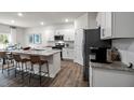 Modern kitchen with granite countertops, stainless steel appliances, and a center island with seating at 818 Comice Pear Way, Willow Springs, NC 27592
