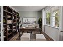 Stylish home office with built-in bookshelves, a large window, and neutral decor at 818 Comice Pear Way, Willow Springs, NC 27592
