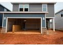 View of garage with gray siding at 829 Ottawa Dr, Garner, NC 27529