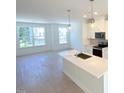 Modern kitchen showcasing white cabinetry, stainless steel appliances, and a center island at 1000 Regalia Rd # 1, Durham, NC 27713