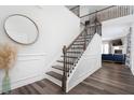 Elegant foyer featuring decorative trim, hardwood floors, and open staircase at 1240 Gemfor St, Durham, NC 27703