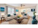 Bright living room features hardwood floors, neutral walls, ceiling fan and glass sliding doors at 127 Finley Forest Dr, Chapel Hill, NC 27517